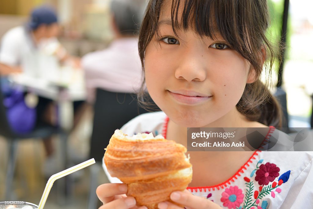 Girl eating croissant