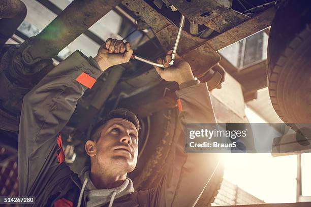 auto mechanic repairing a chassis of a truck. - chassis stockfoto's en -beelden