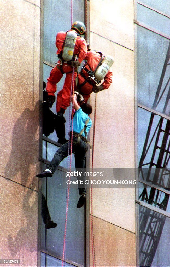 Dangling Red Rope Rescue workers retreive a person dangling from a rope on the Daewoo ...
