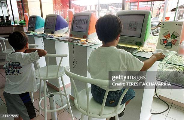 One child watches while another plays with one of the 10 Imac computers installed in local McDonalds in the city of Heredia, 10 kilometers from San...