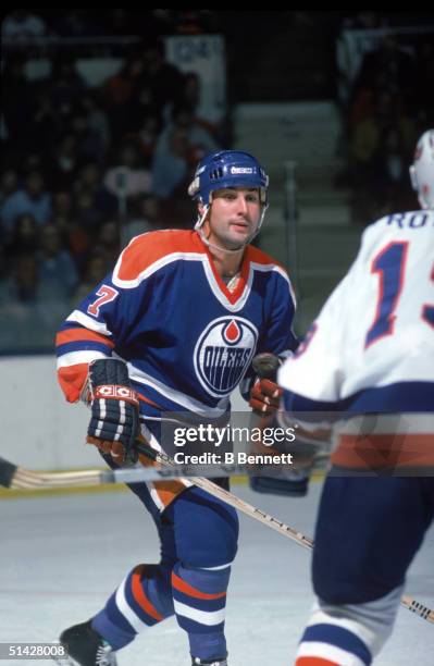 Defenseman Paul Coffey of the Edmonton Oilers skates against the New York Islanders skates during a game in November of 1985 at Nassau Veterans...