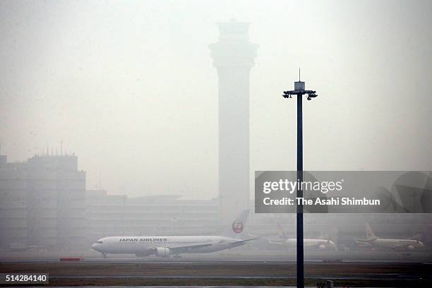 Haneda International Airport is covered with dense fog on March 8, 2016 in Tokyo, Japan. 34 flights from the airport were cancelled.