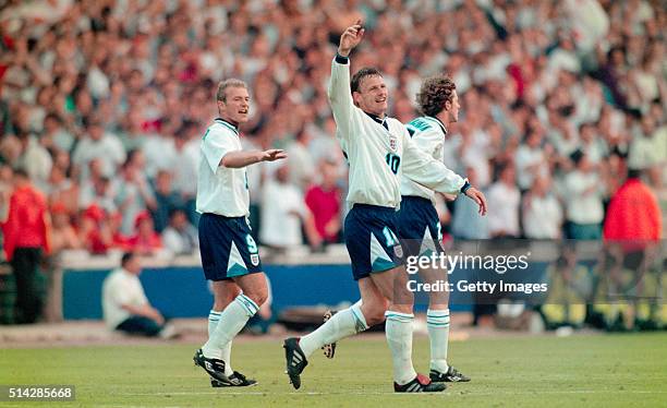 England players Alan Shearer and Steve McManaman celebrate with goalscorer Teddy Sheringham after he had scored the second goal during the 1996...