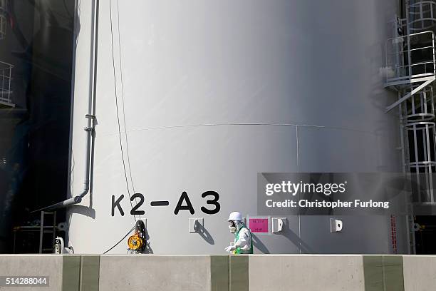 Worker carries out work on new radiation contaminated water tanks at Fukushima Daiichi nuclear power plant on February 24, 2016 in Okuma, Japan. Five...