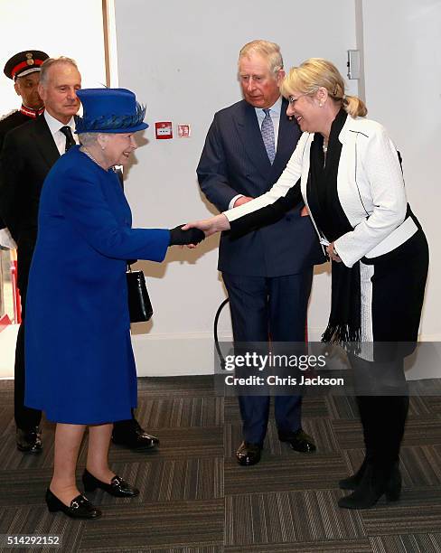 Of the Prince's Trust Martina Milburn greets Queen Elizabeth II and Prince Charles, Prince of Wales at the Prince's Trust Centre in Kennington on...