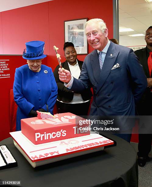 Of the Prince's Trust Martina Milburn claps as Queen Elizabeth II and Prince Charles, Prince of Wales cut a 40th Anniversary cake at the Prince's...