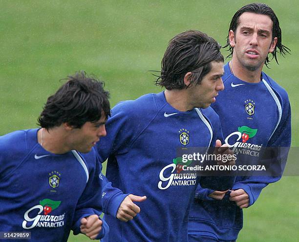 Brazilian soccer players Kaka Leite of the Italian team Milan, Juninho Pernambucano of French Olympique and Edu Gaspar of British Arsenal jog under...
