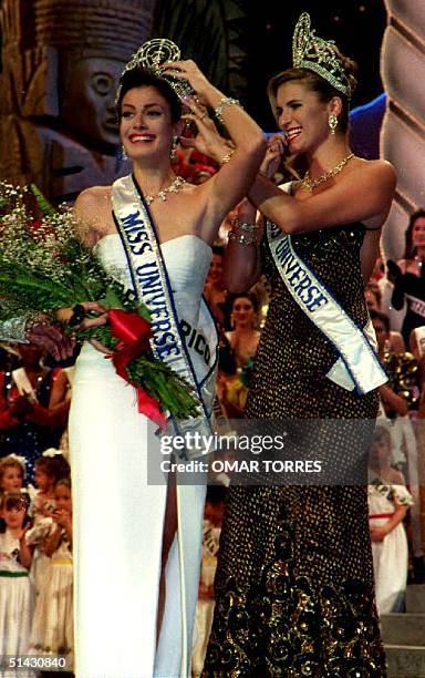 Michelle McLean, Miss Universe 1992 of Namibia puts the crown on Dayanara Torres of Puerto Rico , the new Miss Universe on March 24.