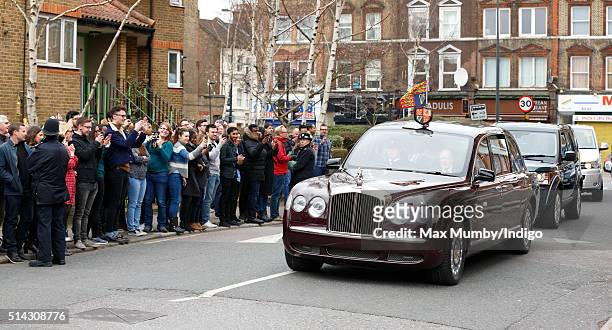 Members of the public line the street as Queen Elizabeth II and Prince Charles, Prince of Wales arrive in The Queen's Bentley car for a visit to The...