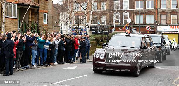 Members of the public line the street as Queen Elizabeth II and Prince Charles, Prince of Wales arrive in The Queen's Bentley car for a visit to The...