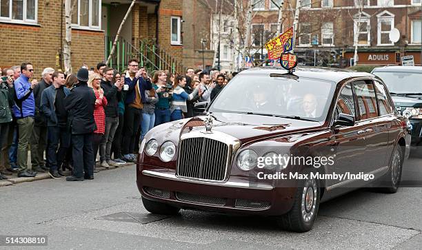 Members of the public line the street as Queen Elizabeth II and Prince Charles, Prince of Wales arrive in The Queen's Bentley car for a visit to The...