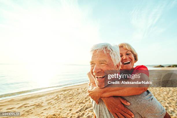 forever young - couple running on beach stock pictures, royalty-free photos & images