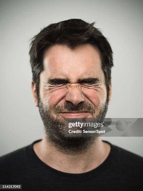portrait of a caucasian real young man - grimacing 個照片及圖片檔