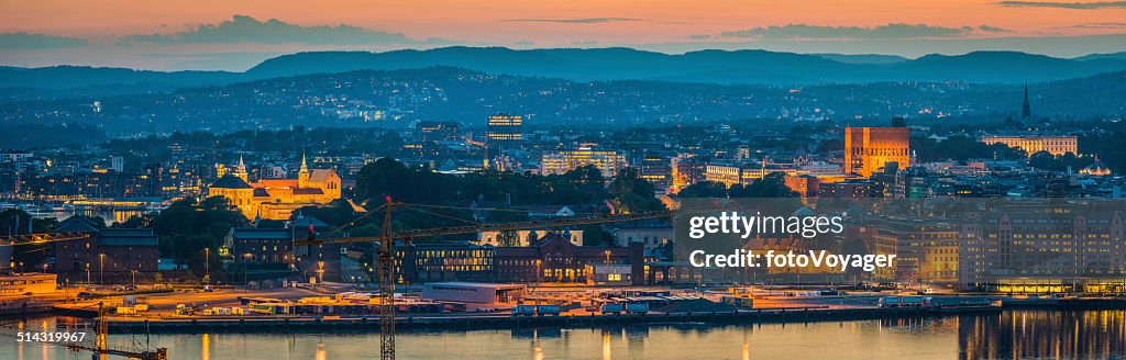 Oslo landmarks illuminated at sunset overloking harbour panorama Norway