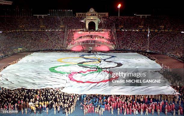 Giant Olympic flag covers the pitch during the opening ceremony of the XXVth summer Olympic Games at Montjuic stadium 25 July 1992.