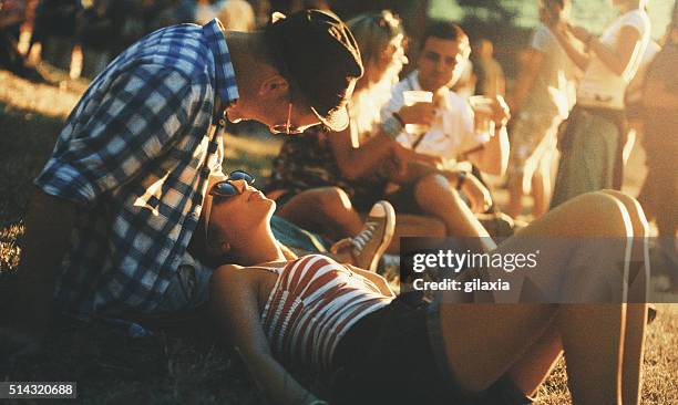 hanging out before the concert. - music festival grass stock pictures, royalty-free photos & images