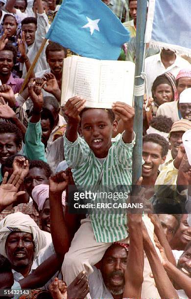 Child displays the Koran during a demonstration against the United States by supporters of fugitive Somali warlord Gen. Mohamed Farrah Aidid 19 June...