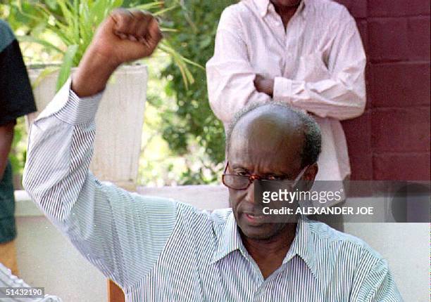 Somali warlord Gen. Mohamed Farrah Aidid raises his fist as he leads a crowd of bystanders in a chant of Allah-o-Akhbar 14 June as he toured the...