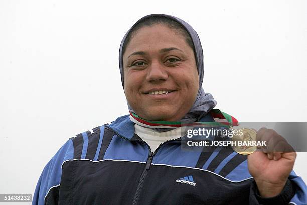 Marwa Arafat of Egypt poses with her gold medal after winning the hammer competition at the 10th Arab Games in Algiers 06 October 2004. AFP...