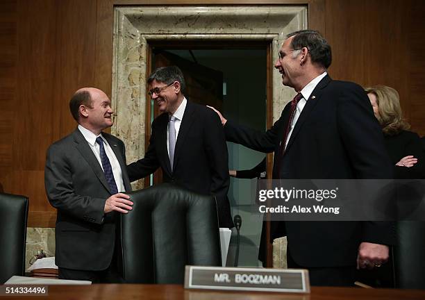 Secretary of the Treasury Jacob Lew is greeted by Sen. Christopher Coons and Sen. John Boozman during a hearing before the Financial Services and...