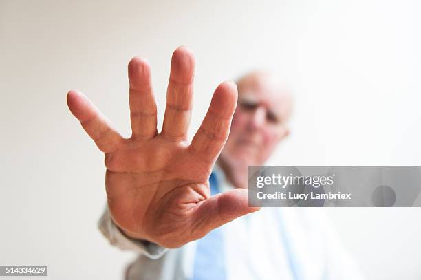 senior man holding off with his hand - open hand stock pictures, royalty-free photos & images
