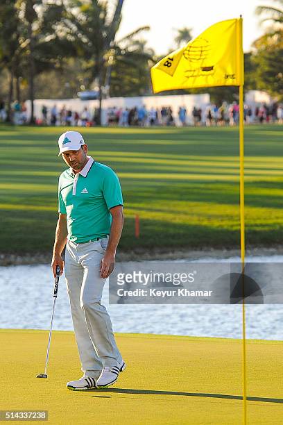 Sergio Garcia of Spain reads his putt on the 18th hole green during the final round of the World Golf Championships-Cadillac Championship at Blue...