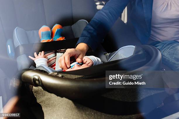 mother and baby in car. - baby car seat stock pictures, royalty-free photos & images