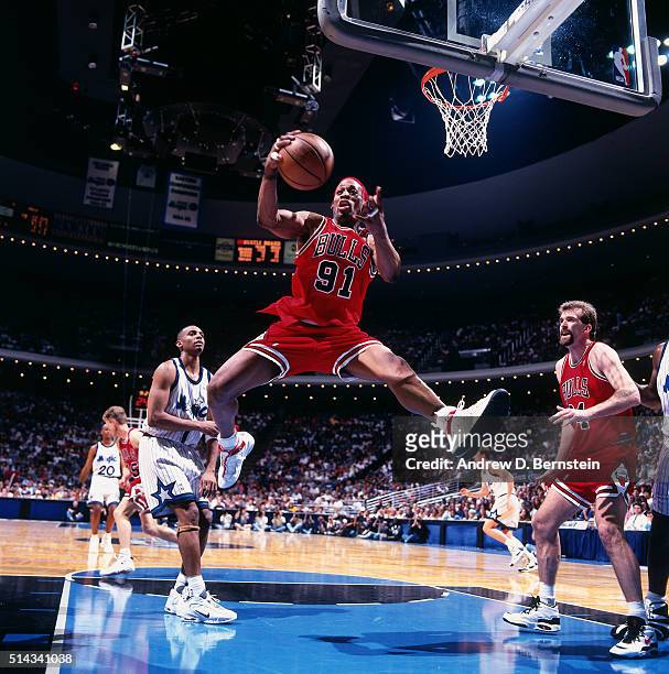 Dennis Rodman of the Chicago Bulls rebounds against the Orlando Magic on April 7, 1996 at Orlando Arena in Orlando, Florida. NOTE TO USER: User...