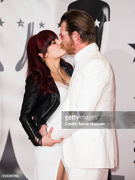 Jesse Hughes kisses Tuesday Cross as they attend the BRIT Awards 2016 at The O2 Arena on February 24, 2016 in London, England.