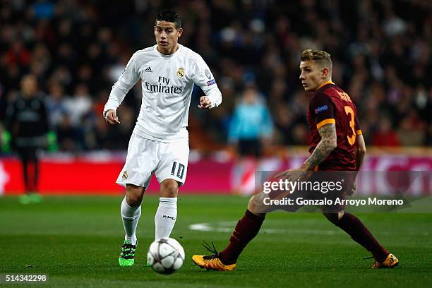 James Rodriguez of Real Madrid is closed down by Lucas Digne of Roma during the UEFA Champions League Round of 16 Second Leg match between Real...