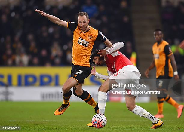 David Meyler of Hull City tangles with Mohamed Elneny of Arsenal during the Emirates FA Cup Fifth Round Replay match between Hull City and Arsenal at...