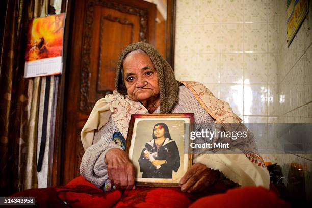 Satya Rani Chadha showing a picture of her daughter killed for dowry on February 17, 2014 in New Delhi, India.