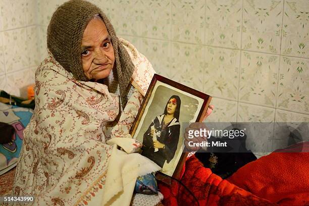 Satya Rani Chadha showing a picture of her daughter killed for dowry on February 17, 2014 in New Delhi, India.