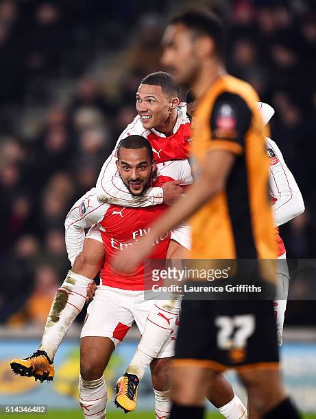 Theo Walcott of Arsenal celebrates scoring his team's third goal with Kieran Gibbs during the Emirates FA Cup Fifth Round Replay match between Hull...