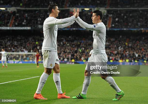 James Rodriguez of Real Madrid celebrates scoring his team's second goal with Cristiano Ronaldo during the UEFA Champions League Round of 16 Second...