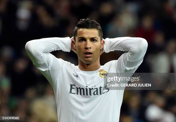 Real Madrid's Portuguese forward Cristiano Ronaldo reacts to missing a goal opportunity during the UEFA Champions League round of 16, second leg...