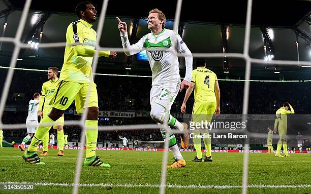 Andre Schuerrle of Wolfsburg celebrates after scoring his teams first goal during the UEFA Champions League Round of 16 Second Leg match between VfL...