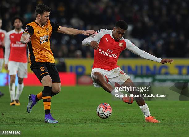 Alex Iwobi of Arsenal takes on Ryan Taylor of Hull during the Emirates FA Cup 5th Round replay between Hull City and Arsenal at the KC Stadium on...