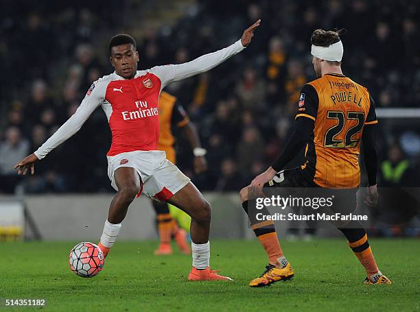 Alex Iwobi of Arsenal takes on Nick Powell of Hull during the Emirates FA Cup 5th Round replay between Hull City and Arsenal at the KC Stadium on...