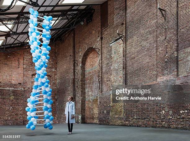 doctor in warehouse with dna made of balloons - balloons concept stockfoto's en -beelden