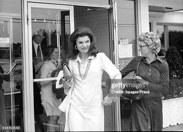 Jacqueline Kennedy Onassis exits a Howard Johnson restaurant after having a meal there after Caroline Kennedys Graduation from Concord Academy on...