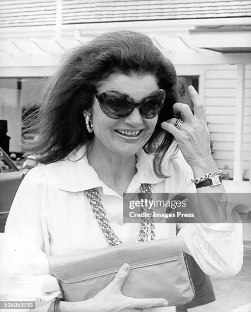 Jacqueline Kennedy Onassis wearing sunglasses exits a Howard Johnson restaurant after having a meal there after Caroline Kennedys Graduation from...