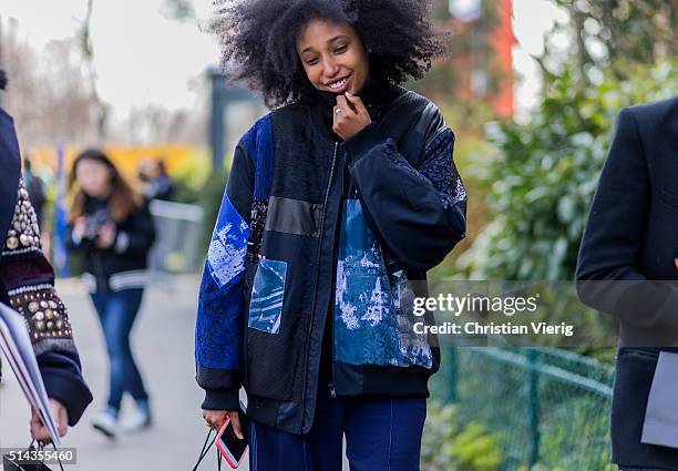 Julia Sarr Jamois is wearing a navy blue bomber jacket outside Chanel during the Paris Fashion Week Womenswear Fall/Winter 2016/2017 on March 8, 2016...