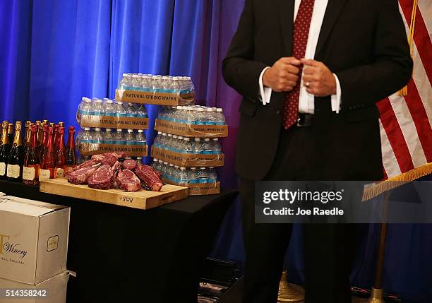 Security agent stands near a display of products that Republican presidential candidate Donald Trump has for guests, including meat, wine and water...