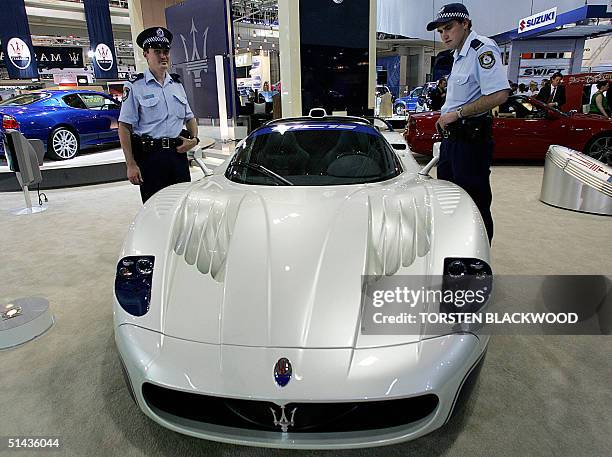 Police constables Brett Douglas and Sean McLoughlin admire the USD 1.3 million carbon-fibre Maserati MC12 sports car capable of 330 km/h at the...