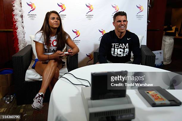 Divers Kassidy Cook and Troy Dumais compete in a video game at the USOC Olympic Media Summit at The Beverly Hilton Hotel on March 8, 2016 in Beverly...