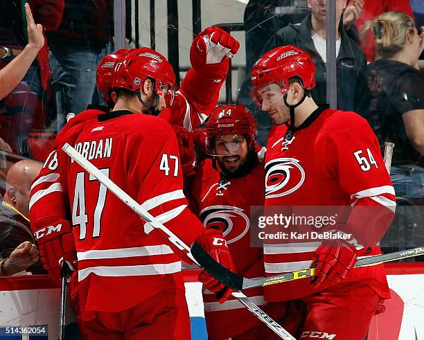 Jay McClement of the Carolina Hurricanes is surrounded by teammates Michal Jordan, Nathan Gerbe and Brett Pesce following his second-period goal...