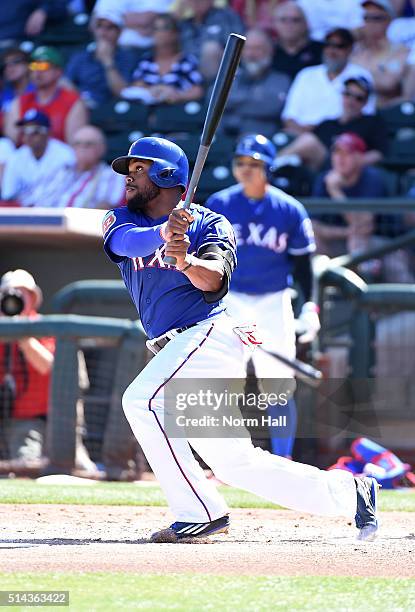 Delino DeShields of the Texas Rangers follows through on a swing against the Los Angeles Dodgers during a spring training game at Surprise Stadium on...
