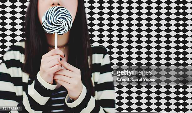 woman with swirl lollipop.pattern background - black nail polish stock pictures, royalty-free photos & images