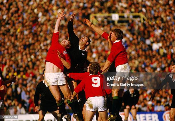 New Zealand's Andy Haden is flanked by Maurice Colclough and Steve Bainbridge of the British Lions as he competes for a restart during the fourth...